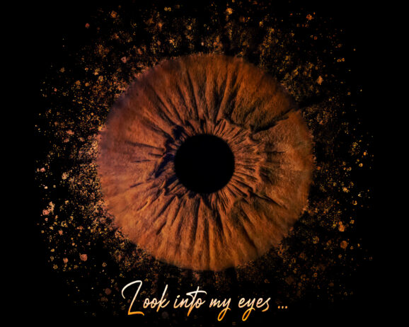 A brown iris surrounded by a dynamic explosion effect, emphasizing the intensity and power of the eye's intricate details